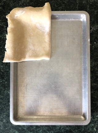 Fold pastry in quarters. Unfold and carefully fit into pan.